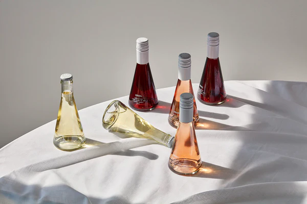 Image of several bottles of Usual wines on a white table cloth