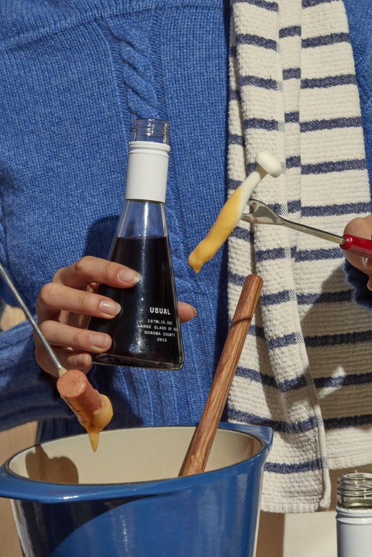 low sulfite wine: woman holding a Usual Wines bottle