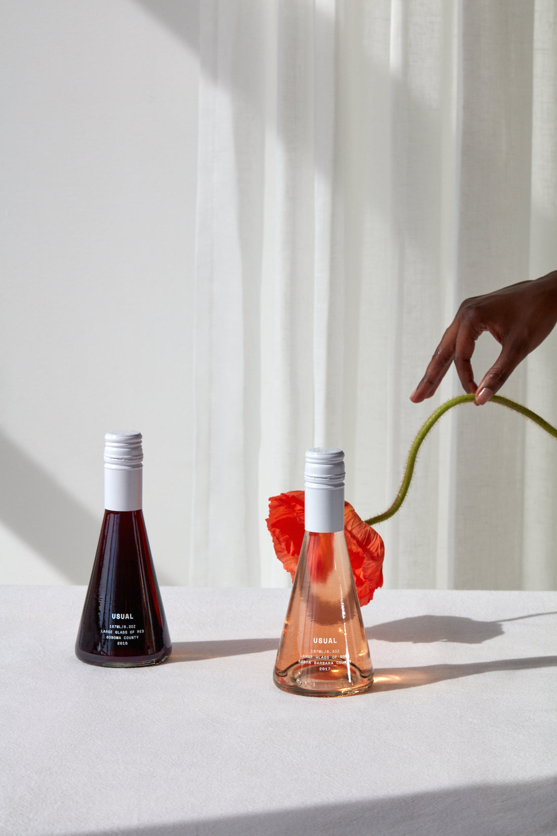 How many calories in a glass of wine? Person puts flower by Usual Red and Rose