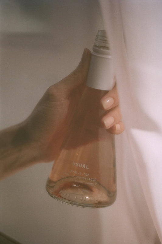 what are sulfites: woman holding a Usual Wines bottle