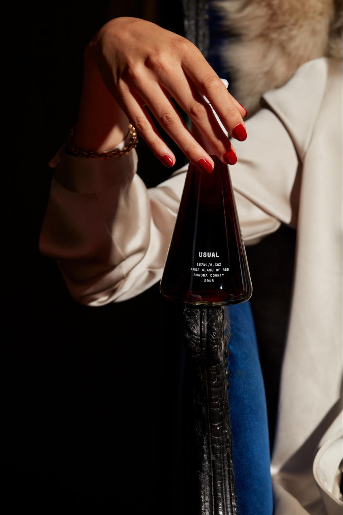 wine decanter: Woman holding a bottle of wine