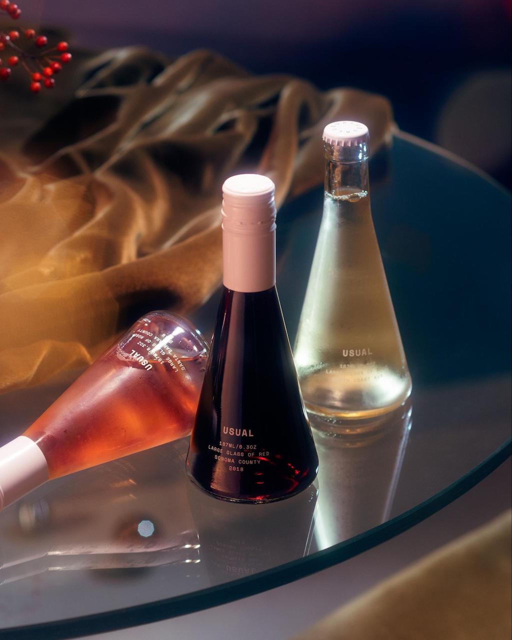 mini wine bottles: Three Usual Wines bottles on a table