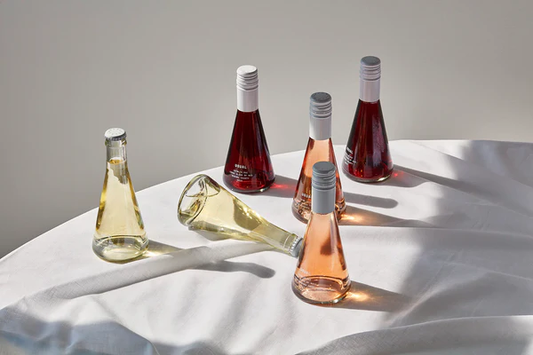 Image of several bottles of Usual wines on a white table cloth