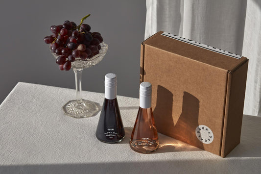 Calories in wine: Usual Wines bottles next to bowl of grapes